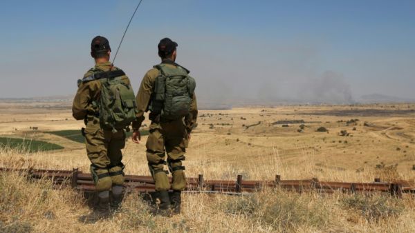 Israeli soldiers patrol near the border with Syria after projectiles fired from the war-torn country hit Israel's Golan Heights on June 24, 2017. (AFP/Jalaa Marey)