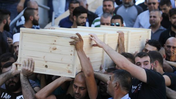 Mourners carry the coffin of Ha'il Satawi, an Israeli policeman from the Arab-Druze minority. (AFP) 
