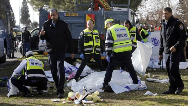 Israeli security forces and emergency personnel gather at the site of a vehicle-ramming attack in Jerusalem on January 8, 2017. (AFP/Menahem Kahana)