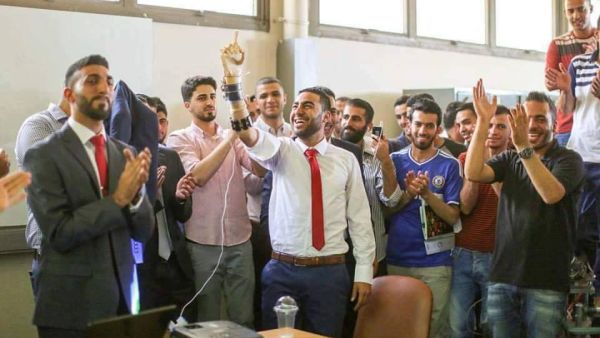 Ahmed Sajdeyya and the prosthetic arm he developed (Facebook)