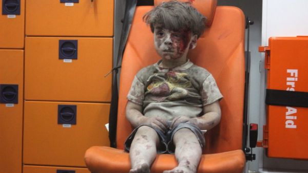 Five-year-old wounded Syrian boy Omran Daqneesh sits alone in the back of an ambulance in Aleppo. (Twitter) 
