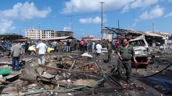 People gather at the site of one of the suicide bombings in Jableh, Syria on May 23. (AFP/File)
