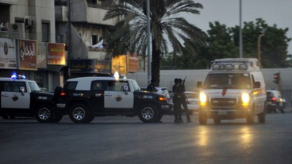 Saudi policemen stand guard at the site of a suicide bombing on July 4, 2016 near the American consulate in Jeddah, the first of three attacks across the country within 24 hours. (AFP/Stringer)