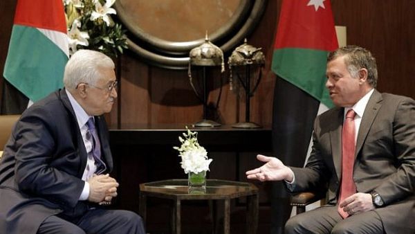 Jordan's King Abdullah II (R) talks with Palestinian Authority President Mahmoud Abbas before a meeting at the Royal Palace in Amman. (AFP/ File)
