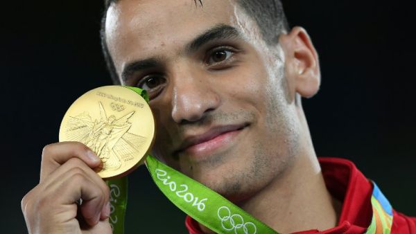 Jordan's Ahmad Abughaush poses with his gold medal on the podium after the men's taekwondo event in the -68kg category as part of the Rio 2016 Olympic Games, on August 18, 2016, at the Carioca Arena 3, in Rio de Janeiro. (AFP/Kirill Kudryavtsev)