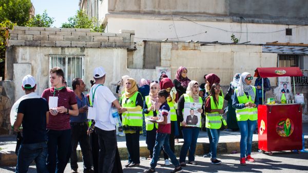 Young Jordanians hand out campaign fliers outside a polling station on Election Day in Amman, Jordan, on Sept. 20, 2016. (Lindsey Leger)
