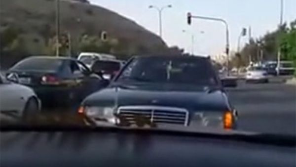 A video circulating on social media shows a black Mercedes driving backwards on a busy street in Amman for 600 meters. (YouTube)