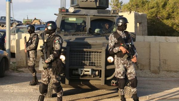 Jordanian security forces are seen on December 19, 2016 during the funeral of victims who were killed a day earlier in an attack at in Karak, around 70 miles south of the capital Amman. (AFP/Khalil Mazraawi) 