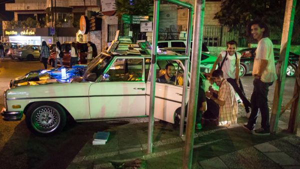 Books are displayed on Nancy, the vintage Mercedes that Ghaith Bahdoosh drives around Amman to bring the joy of reading to the people. (Lindsey Leger)