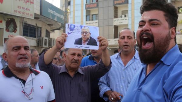 Demonstrators shout slogans during a demonstration in the town of Fuheis, 20km northwest of Amman on September 25, 2016, denouncing the killing of prominent Jordanian writer Nahed Hattar. (AFP/Khalil Mazraawi)