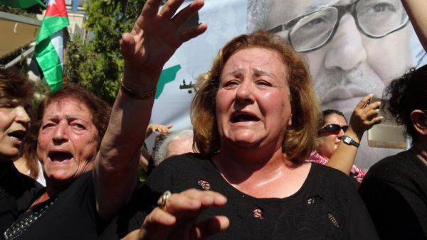 Mourners chant slogans and wave the national flag during the funeral of Jordanian writer Nahed Hattar, who was shot dead earlier this week outside an Amman court, in the town of Fuheis, 20km northwest of the capital Amman on September 28, 2016. (AFP/Khalil Mazraawi)
