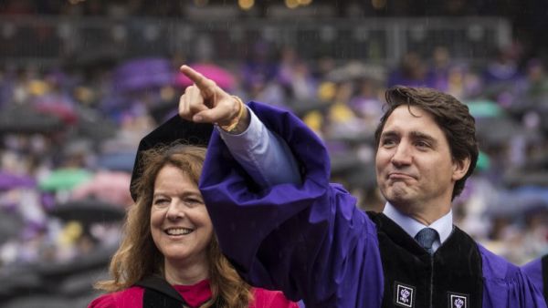 Canadian Prime Minister Justin Trudeau gestures as he arrives for New York University's commencement ceremony/AFP