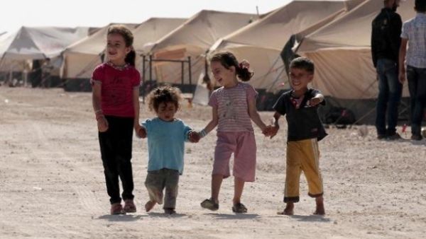 Refugee children walk among tents at the Zaatri refugee camp, near the Jordanian border with Syria. (AFP/ File)