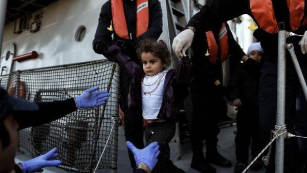 A little girl looks on upon arrival at the northern island of Lesbos after crossing the Aegean sea with other migrants and refugees from Turkey /AFP