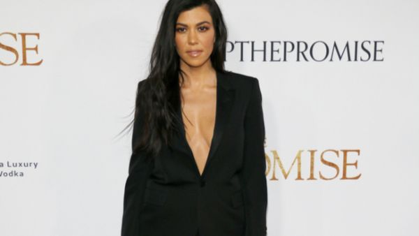 When Kourtney was posing for a mirror selfie with Khloe and Kim, they pretty much ignored her (Source: Tinseltown - Shutterstock)