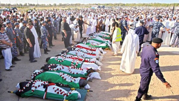Mourners pray over the bodies of the victims of the al-Imam al-Sadeq mosque bombing in Kuwait City on June 27, 2015. (AFP/File)