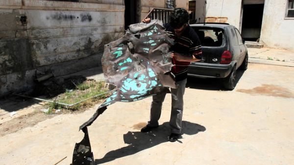 A Libyan man inpects one of the two police stations that were attacked on May 10, 2013 in the eastern Libyan city of Benghazi. Bomb attacks targeted two police stations in Benghazi causing extensive material damage but no casualties, a security official said. (Abdullah Doha/ AFP)