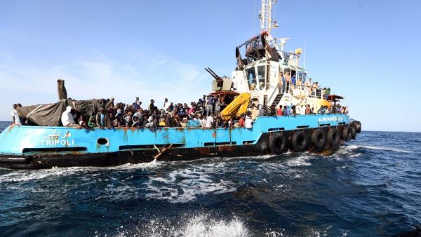 A Libyan coastguard boat carrying migrants near the port of Misrata. (AFP/Mahmud Turkia)