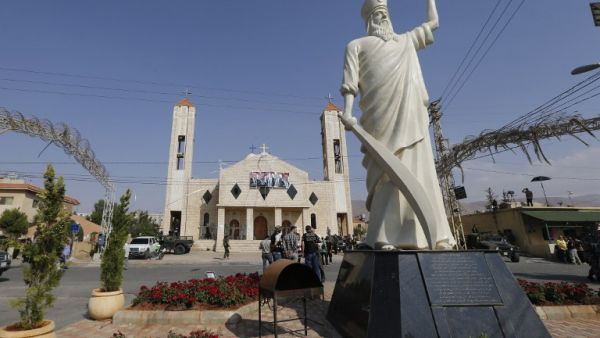 A statute of Saint Elie stands in front of a church where suicide attacks took place earlier this week in the village of al-Qaa, near the country's border with war-ravaged Syria, on June 29, 2016. (AFP/Joseph Eid)