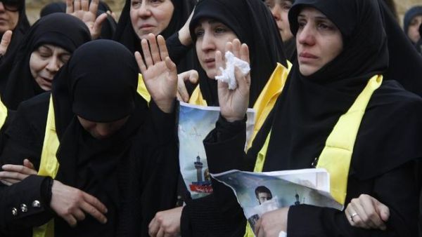 Mourners gesture during the funeral of Mohammed Hijazi, a member of Lebanon's Hezbollah movement who was killed in combat alongside Syrian government forces in Syria, on February 1, 2016, in the Lebanese capital Beirut. (AFP/Stringer)