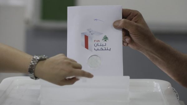 A Lebanese man puts his checked ballot in the box as he casts his vote in the first parliamentary election in nine years. (AFP/ File Photo)
