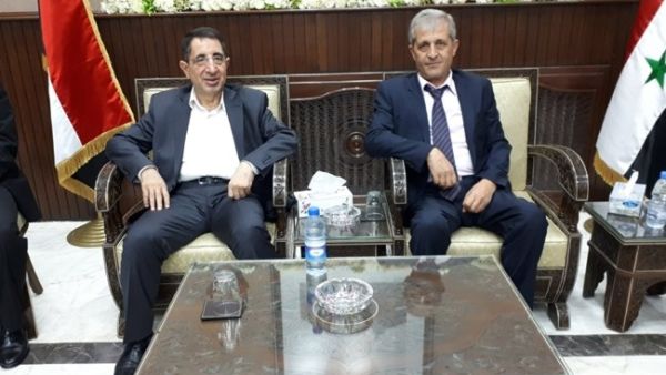 Hezbollah MP and caretaker Industry Minister Hussein Hajj Hasan (L) meets with the Syrian economy and trade minister in Syria on Sept. 6, 2018 (The Daily Star)
