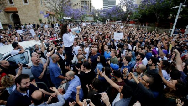 Independent parliamentary candidate Joumana Haddad speaks to members of a civil society movement rallying in front of the Ministry of Interior in Beirut contesting the unofficial results/ AFP