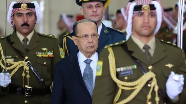 Lebanese President Michel Aoun (C) and Jordan's King Abdullah II (unseen) review the honour guard during an official welcome ceremony at Marka airport in Amman on February 14, 2017. (AFP/Khalil Mazraawi)