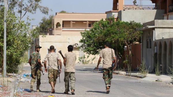 Government of National Accord forces walk through Sirte, Libya. (AFP/Mahmud Turkia)
