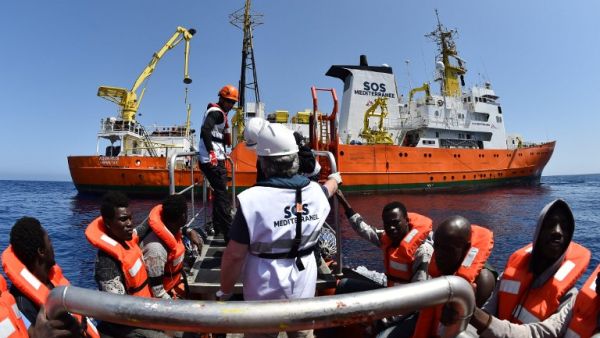 Migrants and refugees are seen during a rescue operation at sea of the Aquarius, a ship now used by humanitarians SOS Mediterranee and Medecins Sans Frontieres, on May 24, 2016 off the Libyan coast. (AFP/Gabriel Bouys)