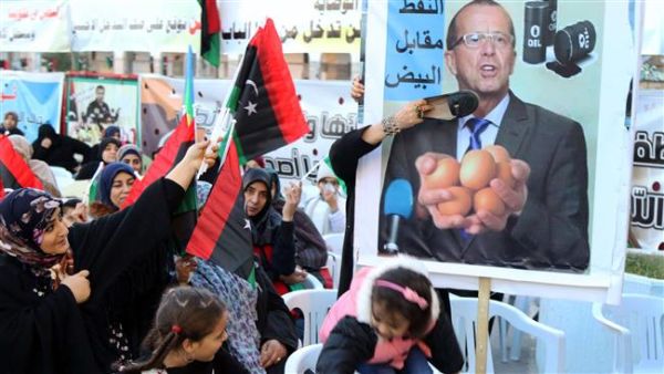 Women place a shoe on a placard bearing a portrait of UN Special Envoy for Libya Martin Kobler during a demonstration against a UN-sponsored agreement on forming a national unity government in the capital, Tripoli, January 8, 2016. (AFP/File)
