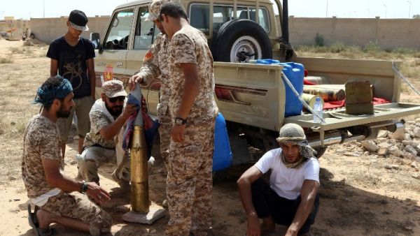 Fighters from forces loyal to Libya's Unity Government gather next to a pick up truck on July 2, 2016 as they take position to hit Daesh targets in Sirte during an operation to recapture the coastal city. (AFP/Mahmud Turkia)