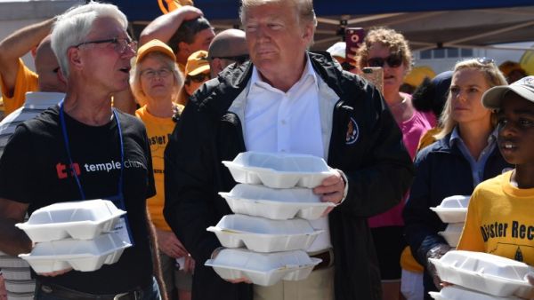 US President Donald Trump greets residents with prepared meals September 19, 2018 in New Bern, North Carolina as he tours areas of the eastern state pummeled by Hurricane Florence. 
Nicholas Kamm / AFP