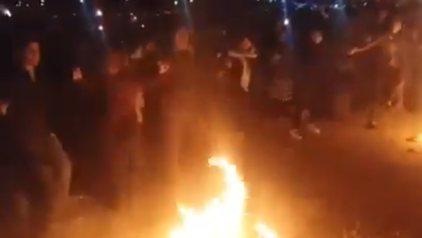Iranians dancing around fire during the Nowruz celebrating the Persian New Year. (Screenshot)
