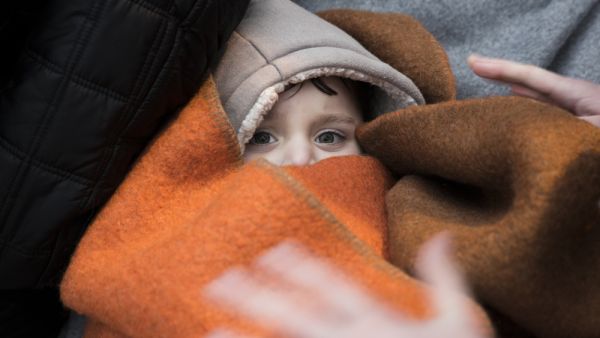 A refugee child wrapped in a blanket (Shutterstock/File Photo)