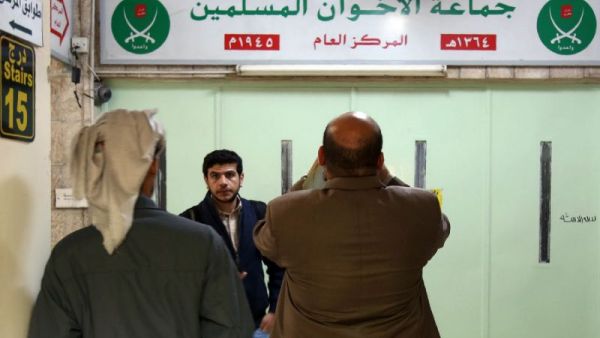 Jordanians check the main entrance of the Muslim Brotherhood's office in Amman. (AFP/File)