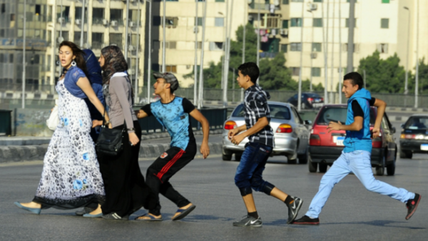 Young boys harass a group of women.