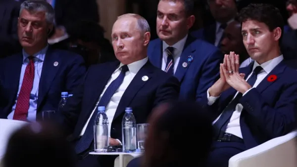 Kosovo's President Hashim Thaci (L), Russian President Vladimir Putin (C) and Canadian Prime Minister Justin Trudeau (R) attend the opening session of the Paris Peace Forum. (GONZALO FUENTES / POOL / AFP)