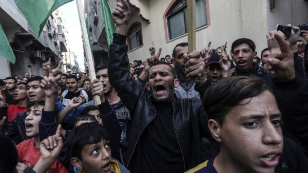Palestinian demonstrators chant slogans before burning pictures of Israeli Defence Minister Avigdor Lieberman in front of the house of Ismail Haniya in Gaza on November 14, 2018. (AFP/File)