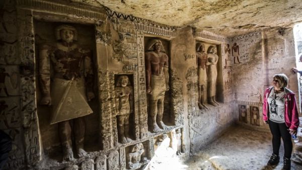 Guests enter a newly-discovered tomb at the Saqqara necropolis belonging to the high priest "Wahtye" who served during the fifth dynasty reign of King Neferirkare. (AFP)