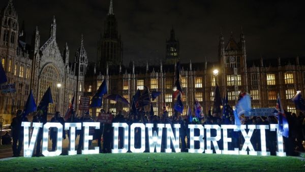 Anti-Brexit demonstrators protest outside Parliament with a giant "Vote Down Brexit" spelled out in illuminated letters. (AFP/ File)