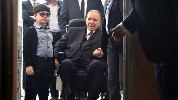Algerian President Abdelaziz Bouteflika arrives on a wheelchair to vote at a polling station in Algiers. (RYAD KRAMDI / AFP)