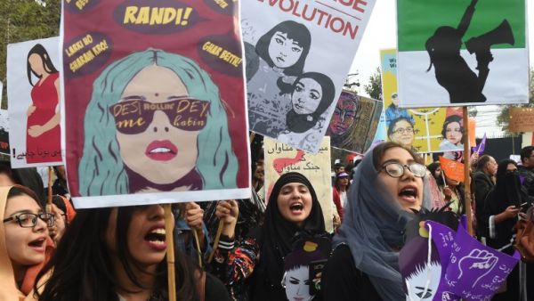 Pakistani civil society activists carry placards and shout slogans during a rally for women rights on International Women's Day in Lahore on March 8, 2019. (ARIF ALI / AFP)