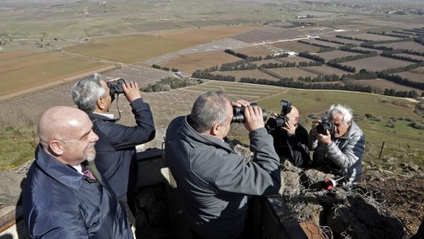 Avigdor Lieberman, Yisrael Beiteinu party leader and Israel's former defence minister, looks through binoculars during a visit to a looking point in Mount Bental in the Israeli-annexed Golan Heights. (AFP)