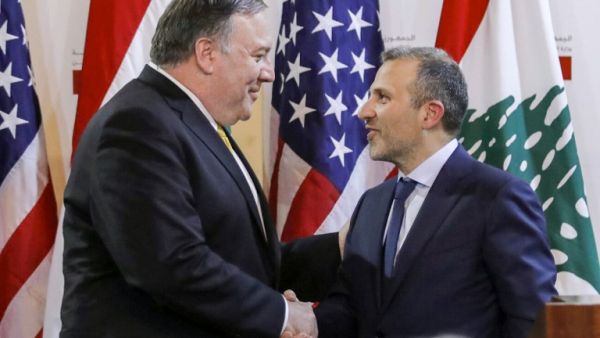 Lebanese Foreign Minister Gibran Bassil (R) shakes hands with visiting US Secretary of State Mike Pompeo following a public statement in the Lebanese capital Beirut on March 22, 2019. (JIM YOUNG / POOL / AFP)