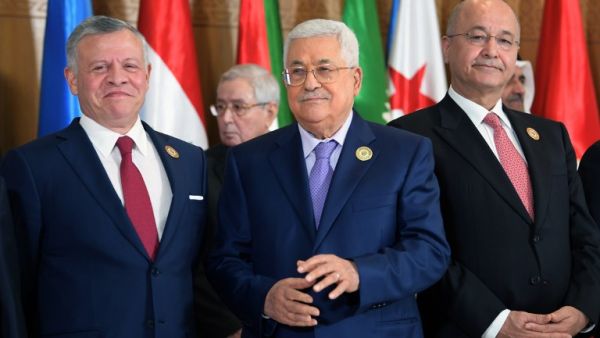 (L to R) Jordan's King Abdullah II, Palestinian president Mahmoud Abbas, and Iraqi President Barham Saleh pose together for the group family photo with other Arab leaders. (AFP/ File)