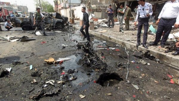 Iraqi security forces inspect the scene of a car-bomb blast targeting Shiite pilgrims on an annual march to a Baghdad. (AFP/ File Photo)