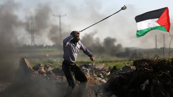 Palestinian protesters hurls a rock at Israeli security forces during clashes near the Shejaiya area of Gaza City . (AFP/ File)