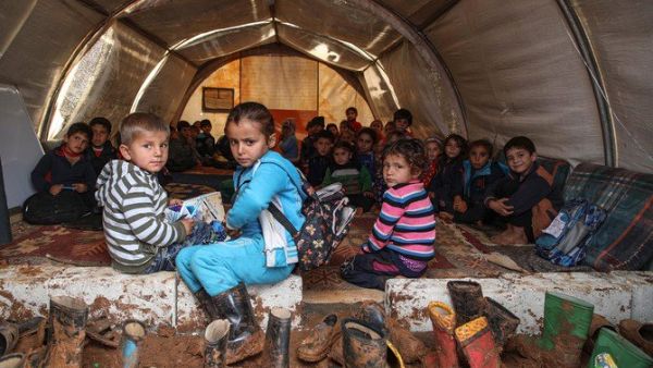 Syrian children gather in a tent repurposed as a make-shift classroom, at a camp for the displaced near the town of Sarmada in the northern countryside of the rebel-held Idlib province on December 1, 2018. (File/ AFP