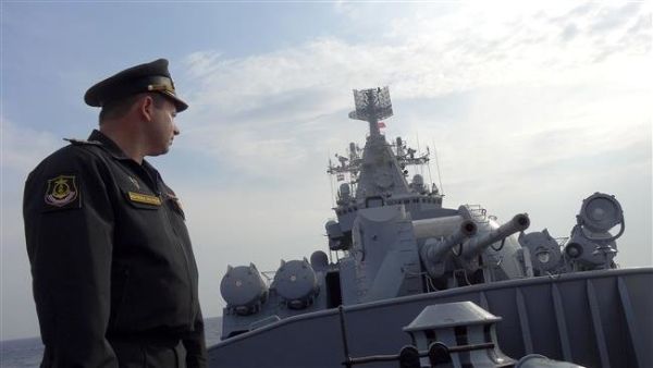 Russian Navy Captain Alexander Shvarts stands in front of an artillery system on the Russian missile cruiser Moskva as it patrols in the Mediterranean Sea. (AFP/File)